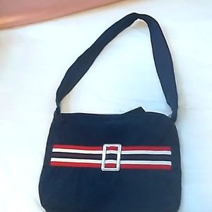 A navy blue purse with stripes and a buckle.
